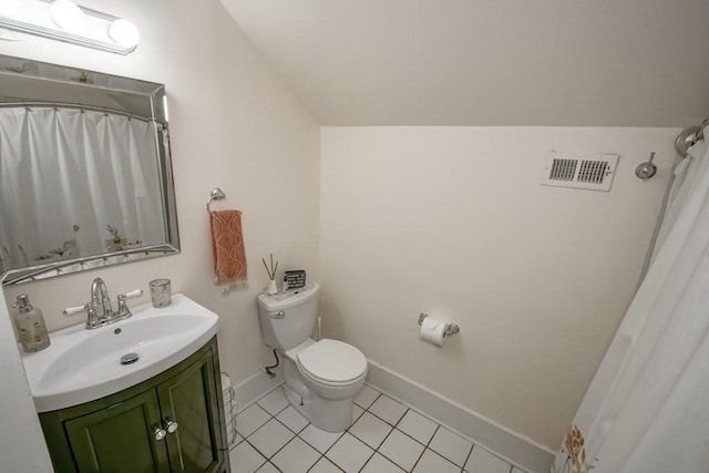 bathroom with tile patterned floors, vanity, lofted ceiling, and toilet