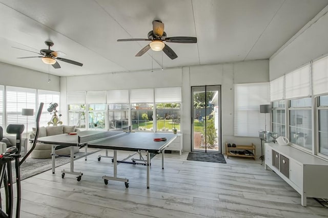 playroom with ceiling fan and light hardwood / wood-style flooring