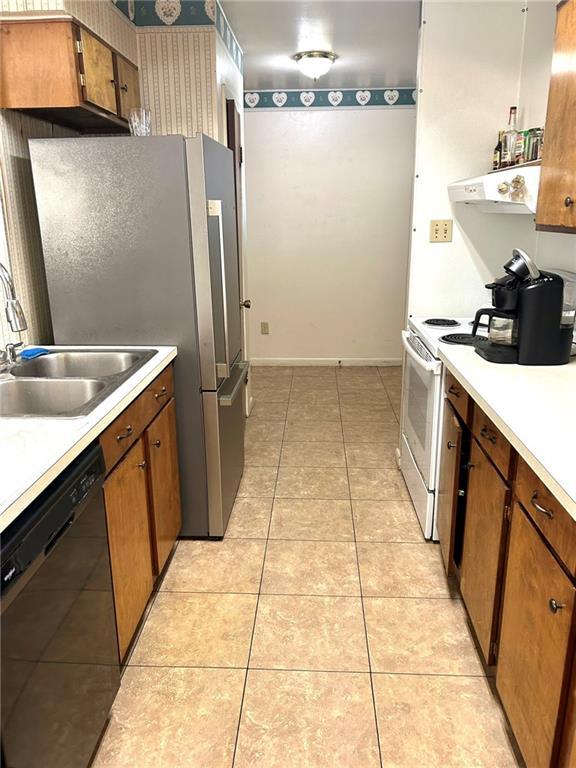 kitchen featuring light tile patterned flooring, sink, stainless steel refrigerator, white electric stove, and dishwasher