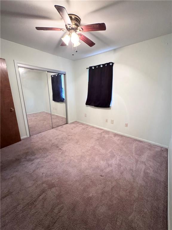 unfurnished bedroom featuring a closet, ceiling fan, and carpet flooring