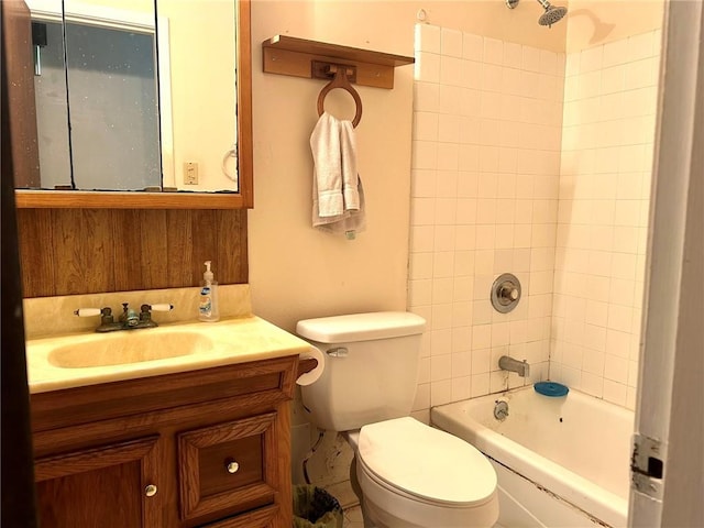 full bathroom with vanity, toilet, and tiled shower / bath combo