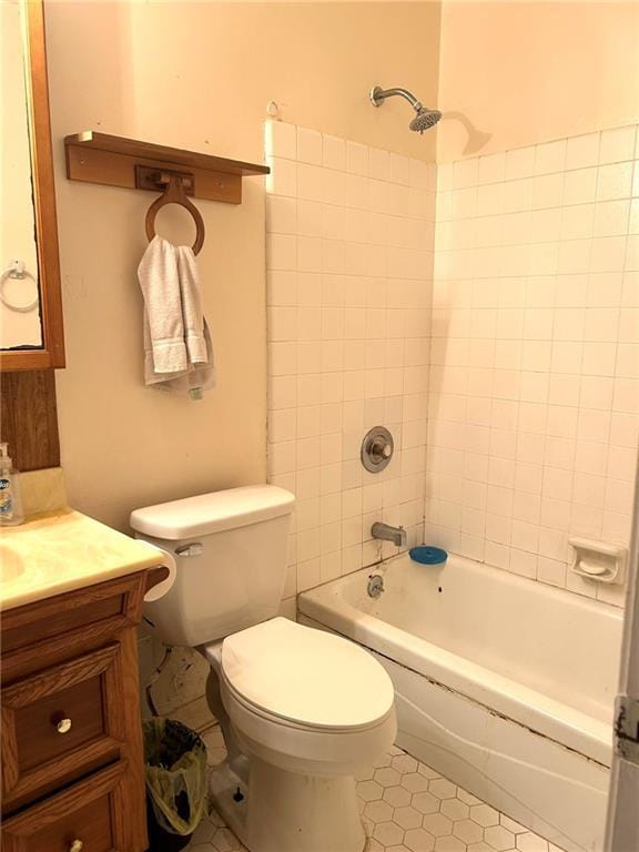 full bathroom featuring vanity, toilet, and tiled shower / bath combo