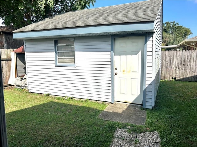 view of outbuilding featuring a lawn