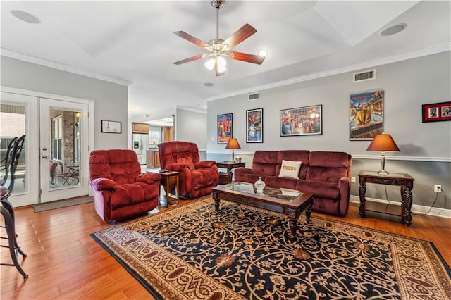 living room featuring ceiling fan, crown molding, and wood-type flooring