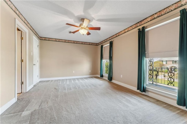 empty room featuring ceiling fan and light carpet