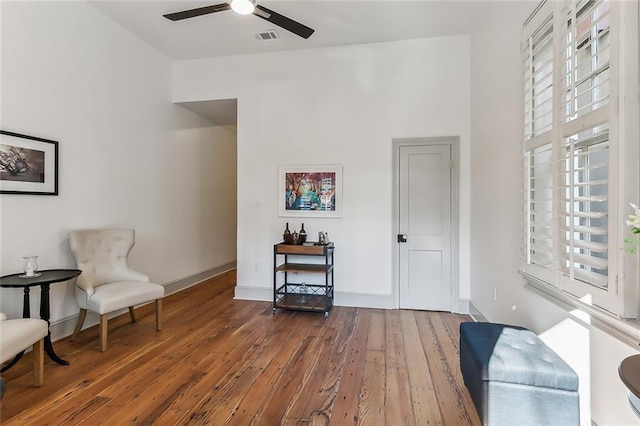 sitting room featuring ceiling fan, hardwood / wood-style flooring, and a healthy amount of sunlight