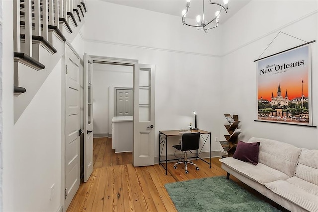 living room featuring an inviting chandelier and wood-type flooring