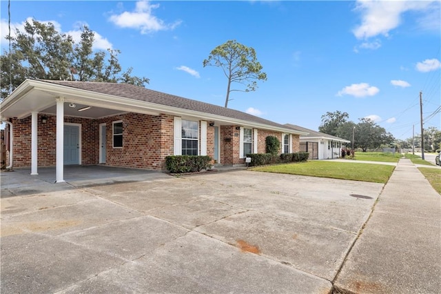 single story home featuring a carport and a front lawn