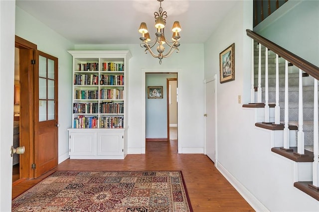 foyer featuring dark hardwood / wood-style floors and a notable chandelier