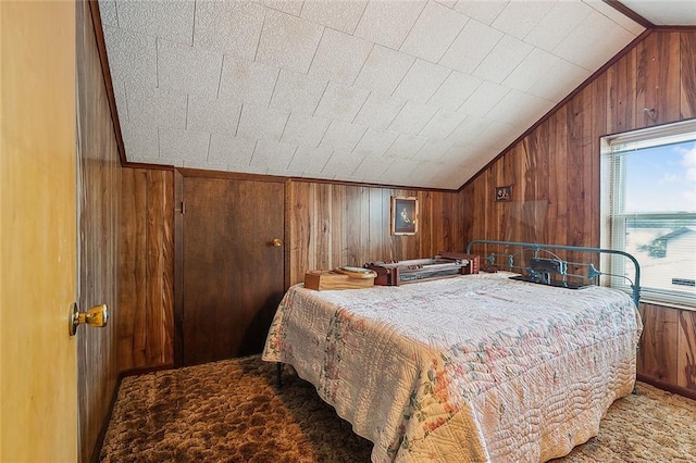 bedroom with vaulted ceiling, wooden walls, and carpet flooring