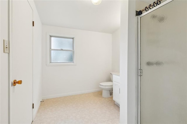 bathroom featuring vanity, toilet, and a shower with door