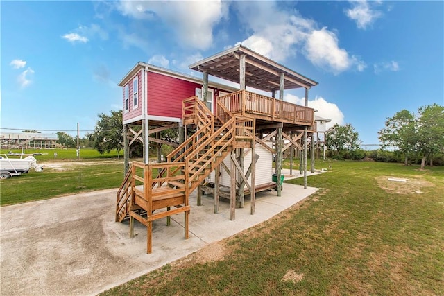 exterior space featuring a patio, a deck, and a yard