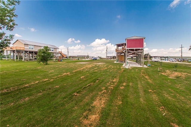 view of property's community with a wooden deck and a yard