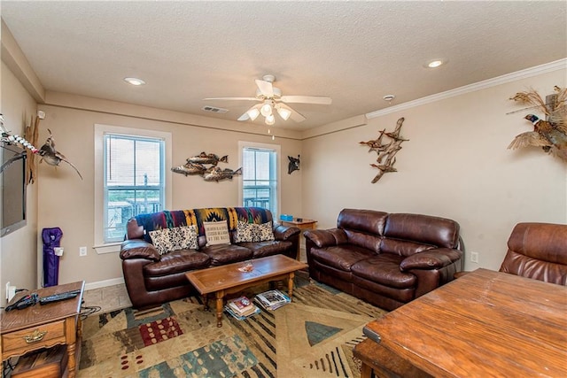 living room featuring a textured ceiling, ceiling fan, and crown molding