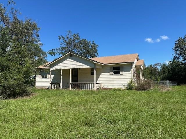 rear view of property featuring a yard