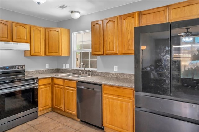 kitchen with ceiling fan, appliances with stainless steel finishes, light tile patterned flooring, and sink