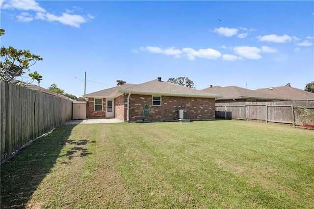 rear view of property with a patio area and a yard