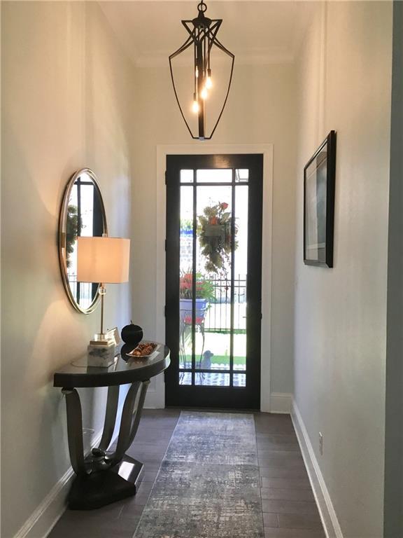 106 Grand Champions Ln, Slidell, LA 70458 - foyer entrance with plenty of natural light, baseboards, wood finished floors, and crown molding