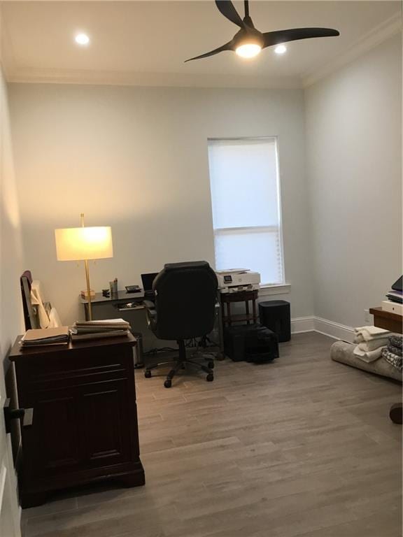 office area with wood-type flooring, ornamental molding, and ceiling fan