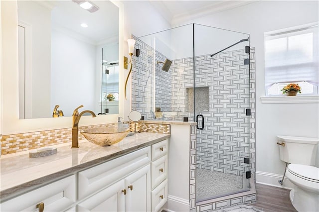 106 Grand Champions Ln, Slidell, LA 70458 - full bathroom featuring crown molding, toilet, vanity, a shower stall, and decorative backsplash