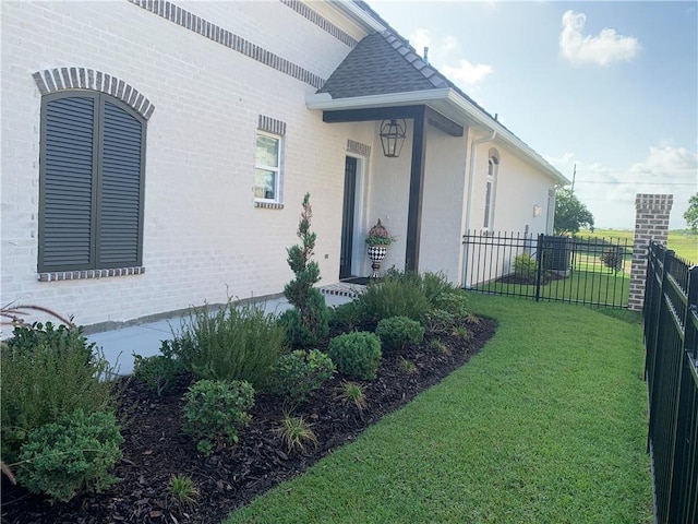 view of exterior entry featuring a yard