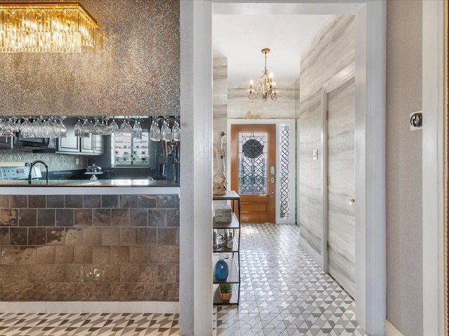 bathroom featuring an inviting chandelier and tile patterned flooring