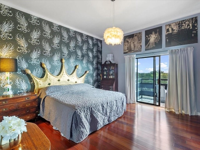 bedroom with crown molding, dark hardwood / wood-style floors, and access to exterior