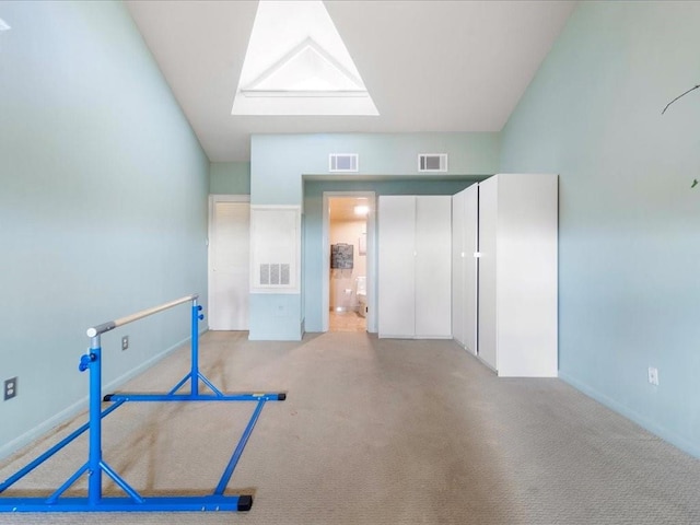 interior space featuring light carpet and a skylight