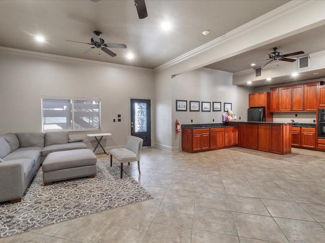 interior space with ceiling fan, black fridge, crown molding, and light tile patterned floors