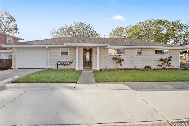 2016 Pelitere Cv, Chalmette, LA 70043 - ranch-style home featuring brick siding, driveway, a front lawn, and a garage