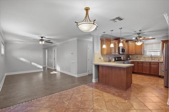 2016 Pelitere Cv, Chalmette, LA 70043 - kitchen with a peninsula, ceiling fan, visible vents, and stainless steel appliances