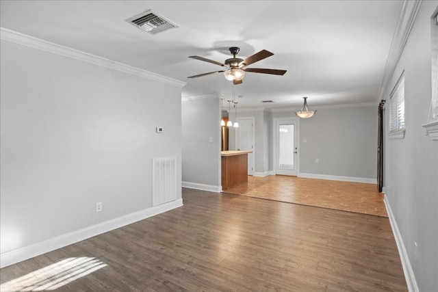 2016 Pelitere Cv, Chalmette, LA 70043 - spare room with ornamental molding, visible vents, a ceiling fan, and wood finished floors