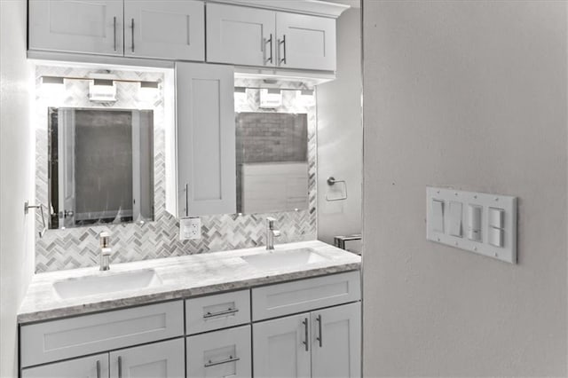 full bath with a sink, double vanity, and decorative backsplash