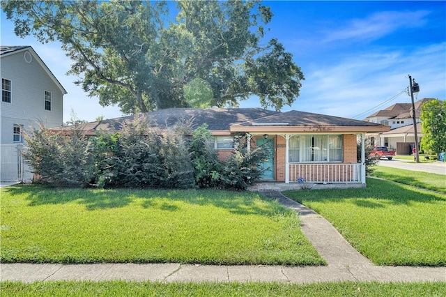 view of front of home featuring a front yard and covered porch