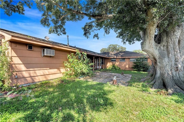 rear view of property featuring a lawn