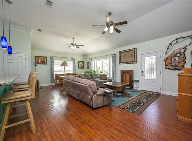 living room featuring ceiling fan, dark hardwood / wood-style floors, and vaulted ceiling