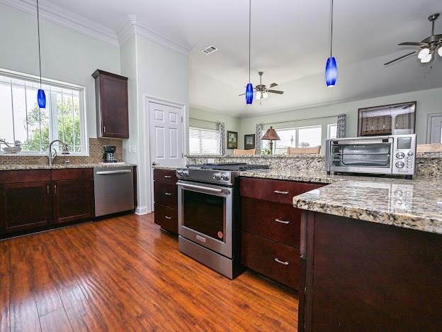 kitchen with ceiling fan, tasteful backsplash, stainless steel appliances, dark hardwood / wood-style floors, and crown molding