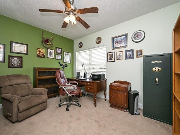 office featuring ceiling fan, light colored carpet, and a textured ceiling