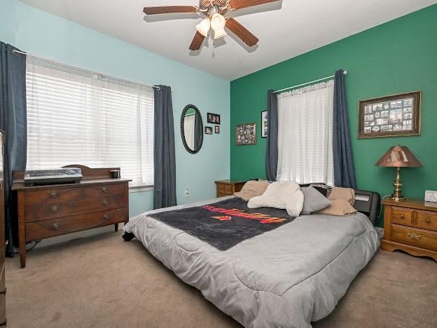 carpeted bedroom featuring ceiling fan