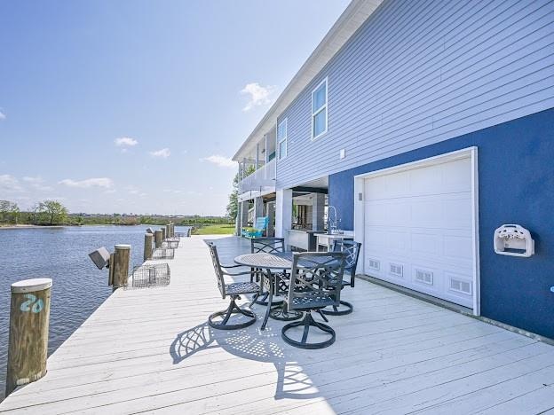 wooden deck featuring a water view