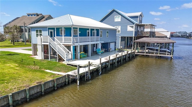 view of dock featuring a lawn and a water view