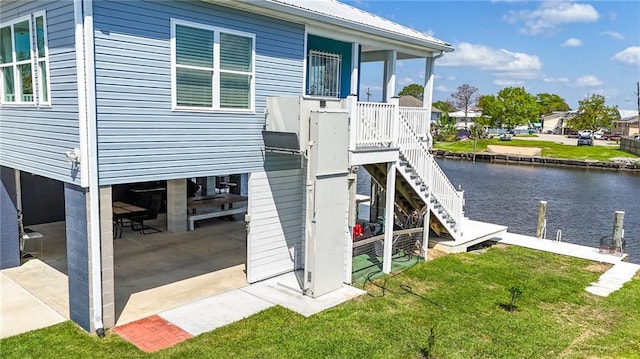 exterior space featuring a lawn and a water view