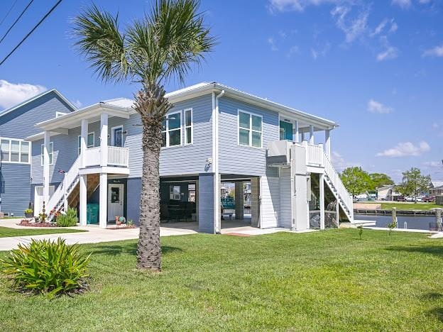 exterior space featuring a front lawn and a patio