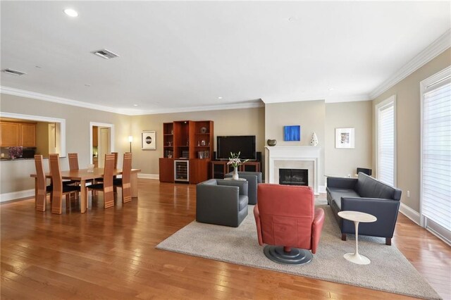416 Common St Unit 6, New Orleans, LA 70130 - living area with a fireplace, wood-type flooring, baseboards, ornamental molding, and recessed lighting