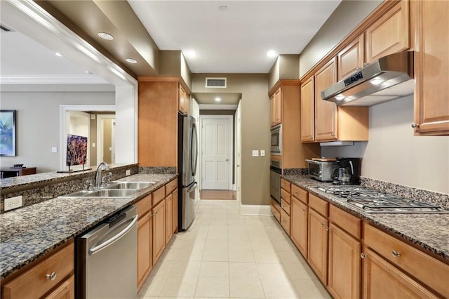 kitchen featuring light tile patterned flooring, ornamental molding, sink, appliances with stainless steel finishes, and dark stone counters