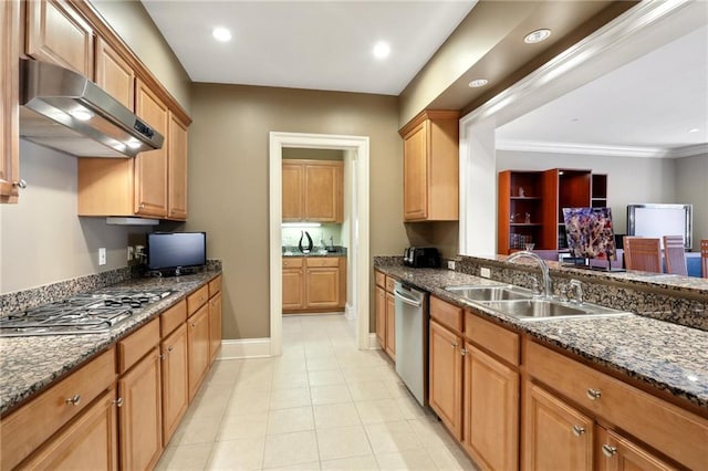 kitchen with sink, stainless steel appliances, light tile patterned floors, ornamental molding, and dark stone countertops