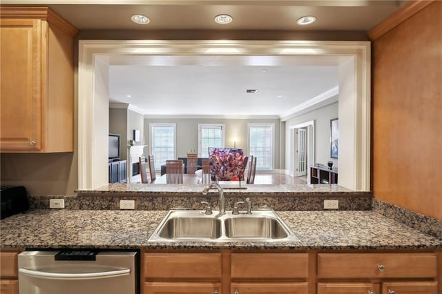 kitchen with dishwasher, crown molding, stone countertops, and sink