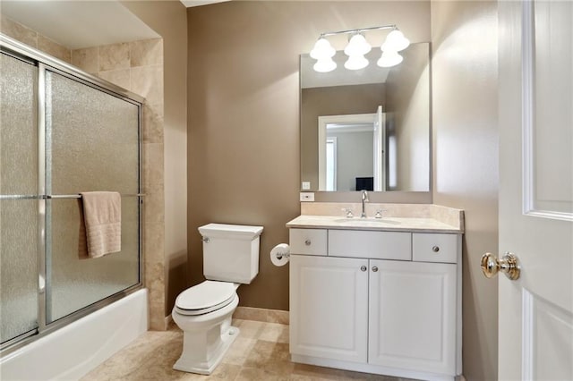 full bathroom featuring vanity, tile patterned flooring, toilet, and combined bath / shower with glass door