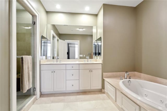 bathroom with shower with separate bathtub, tile patterned floors, and vanity