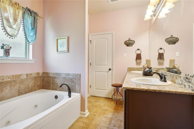 bathroom featuring vanity and a bath